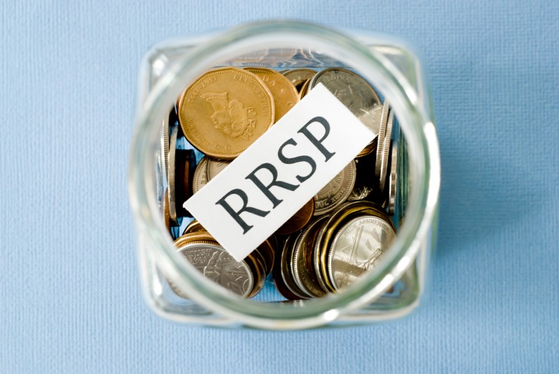 a look down at a jar full of coins with a note reading RRSP in it